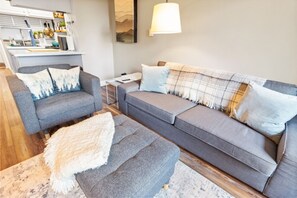 A modern living room with a grey sofa, a matching armchair, and a small side table. - Super Cozy Studio Near Slopes And Shuttle Bus WiFi (Snowshoe)