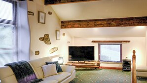 A living room with a sofa, a television, and a patterned carpet. - 1 bedroom accommodation in Combs, near Chapel-en-le-Frith (Combs, near Chapel-en-le-Frith)