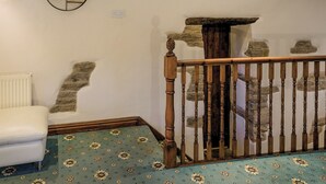 A room with a wooden staircase, a white radiator, and a patterned carpet. - 1 bedroom accommodation in Combs, near Chapel-en-le-Frith (Combs, near Chapel-en-le-Frith)