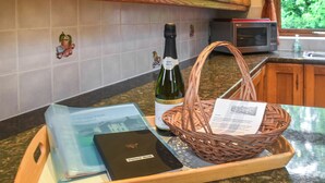 A tray with a wine bottle, a basket, and a book on a kitchen counter. - 4 bedroom accommodation in Hainworth, near Keighley (Hainworth, near Keighley)
