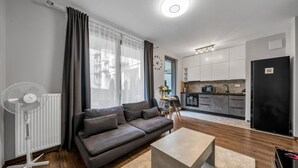 A modern apartment with a living room, kitchenette, and a dining area. - Kasprzaka 29C - Terrace, Workspace, EXPO - by Rentujemy (Warszawa)