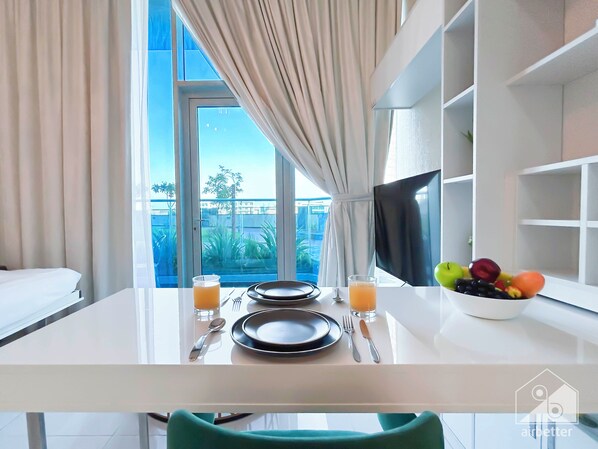 Enjoy a meal in the dining area with a view of the outdoors.