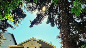 A two-story house with a front porch, a visible front door, and a staircase leading to the front door. - Pretty home in the heart of Edmonton. Main floor, Pet-Friendly! (Edmonton)