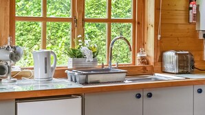 A kitchen with a wooden countertop, a sink, a toaster, and a refrigerator. - 1 bedroom accommodation in Berrow, near Malvern (Berrow, near Malvern)