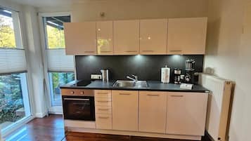 Fridge, stovetop, dishwasher, coffee/tea maker
