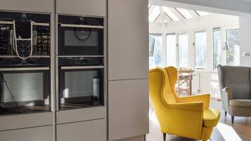 A modern kitchen with built-in appliances and a bright, open layout.