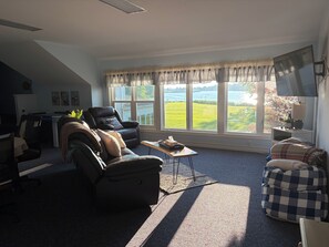 A living room with a sofa, armchair, and a coffee table.