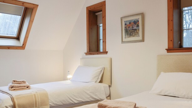 A bedroom with two beds, a window, and a painting on the wall. - 3 bedroom accommodation in Blairgowrie (Blairgowrie)