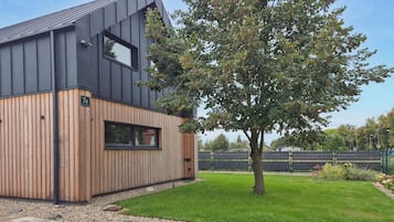 A modern building with a wooden facade and a large window.