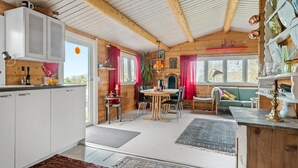 A cozy cabin interior with a kitchen, dining area, and living space. - 3 bedroom stunning home in Slagelse (Slagelse)