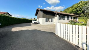 A single-story building with a car parked in front.