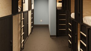A narrow hallway with bunk beds on both sides, wooden paneling, and a central light fixture. - Podtel (Honolulu)
