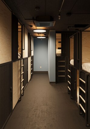 A narrow hallway with bunk beds on both sides, wooden paneling, and a central light fixture. - Podtel (Honolulu)