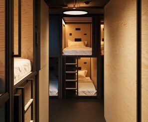 A narrow hallway with a bunk bed and a ladder leading to a lower bunk. - Podtel (Honolulu)