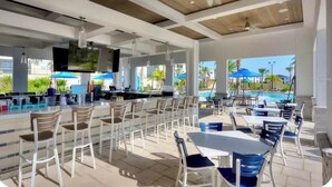 An outdoor bar area with seating and a pool view. - Spacious 5Bdr 5Bth ChampionsGate Villa Near Disney, Private Pool & Resort Access (Davenport)