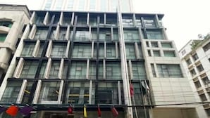 A multi-story building with a modern architectural design, featuring large windows and a symmetrical facade. - Hotel Grace 21 (Dhaka)