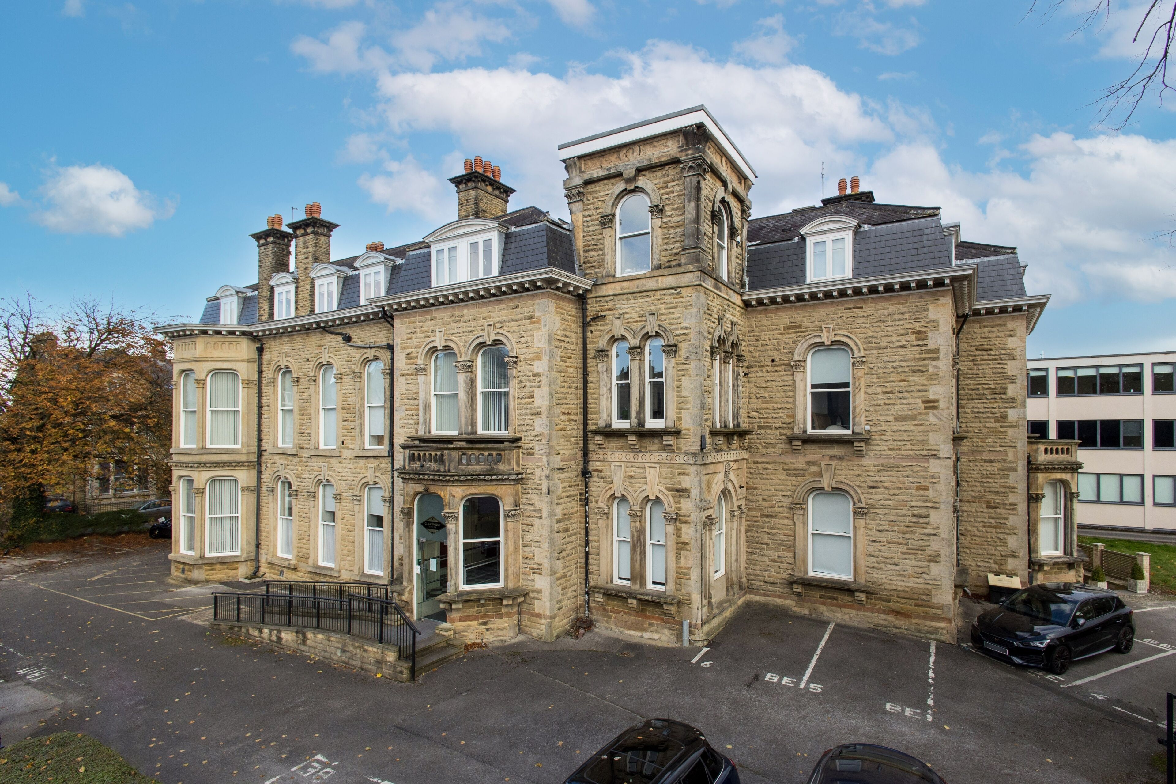 A historic stone building with multiple windows and a central entrance.