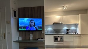 A modern kitchen with a built-in oven, a microwave, and a sink. -  Carre D’Or - Discover a unique address in the heart of Promenade des Anglais.  (Nice)