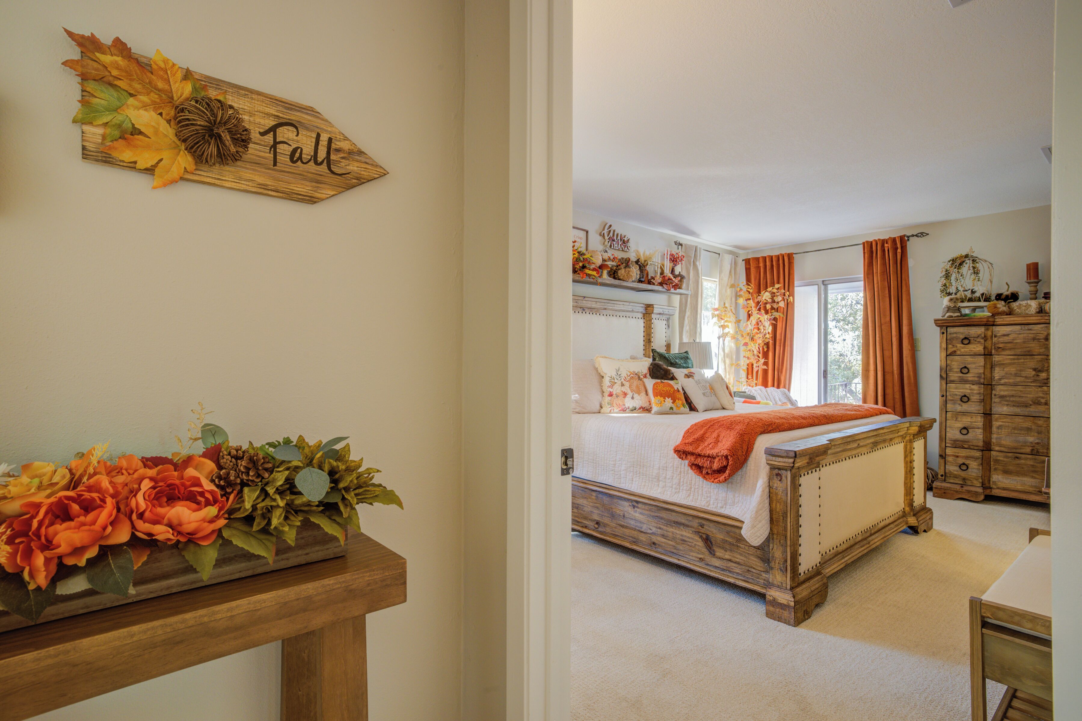 A bedroom with a bed, dresser, and a wall-mounted sign.