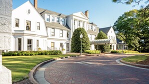 A large, white building with a symmetrical facade, a brick pathway, and well-maintained lawns. - Ducks Landing Accommodations at Southern Pines Golf Course (Aberdeen)