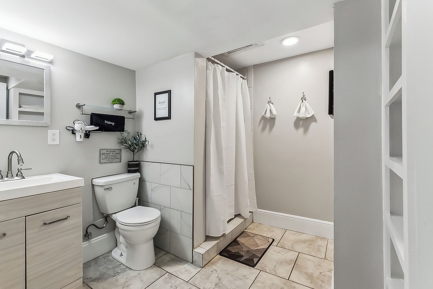 A modern bathroom with a toilet, sink, and shower.