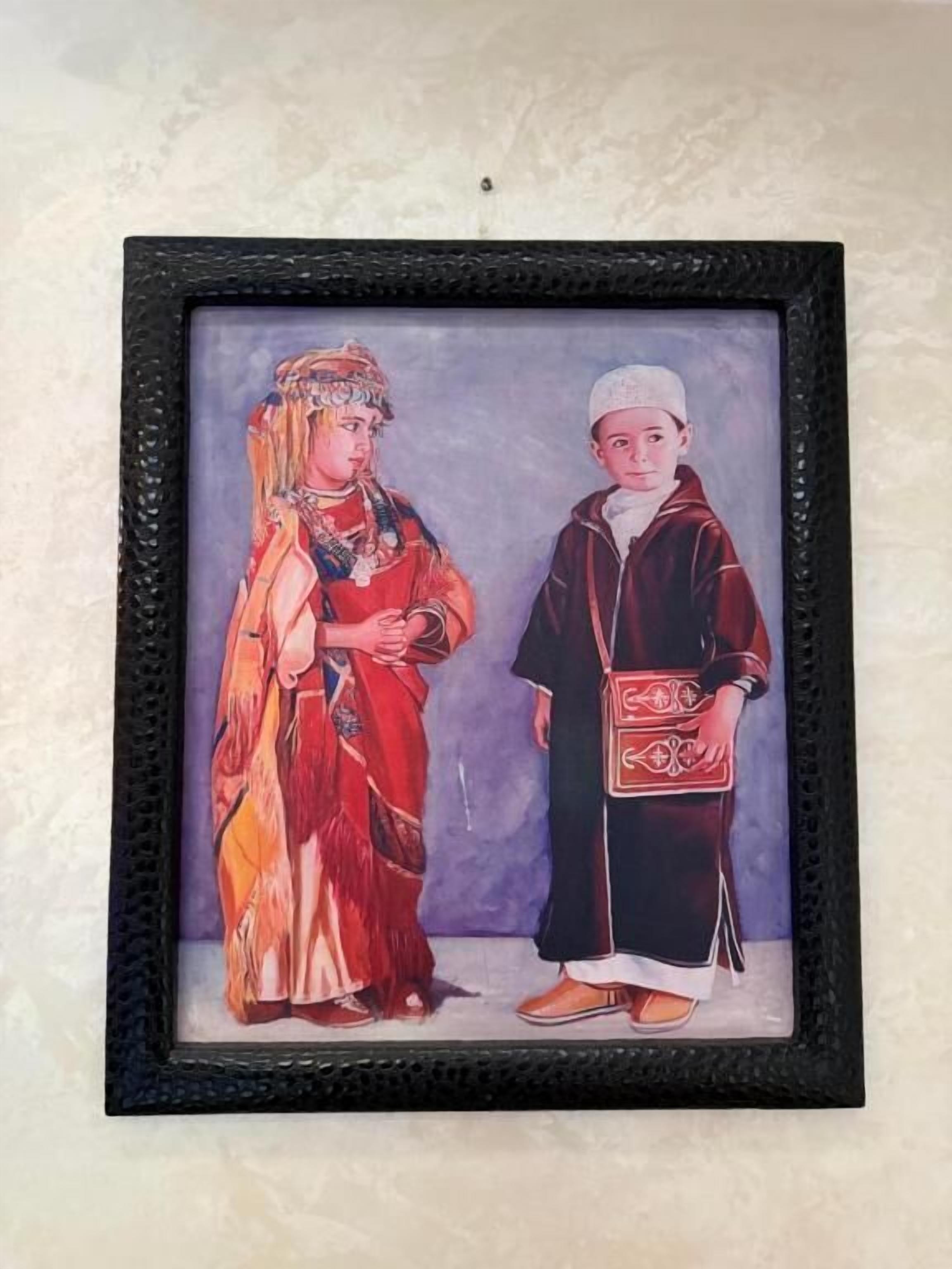 A framed artwork of two individuals in traditional attire.