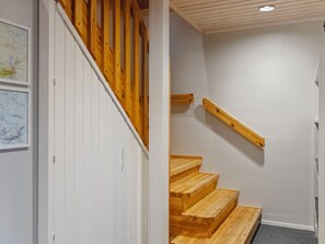 A wooden staircase with a handrail and a carpeted landing. - Villa uuttu by Interhome (Pelkosenniemi)