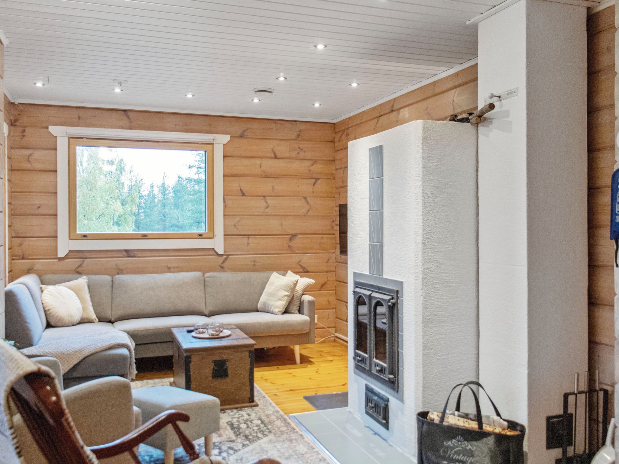 A cozy living room with a sofa, a coffee table, and a fireplace.