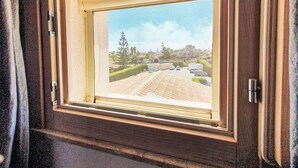A window with a view of a parking lot and buildings. - Casa di Arianna by Interhome (Noto)