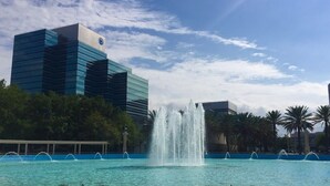 A modern building with a blue facade and a fountain in front. - Spacious 3BR Two-Story Home Near Downtown Jax (Jacksonville)