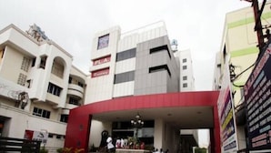 A building with a prominent red entrance, a sign for 'PL.A. Regency', and a modern architectural style. - Hotel PL A Residency Tiruchirappalli (Tiruchirappalli)
