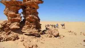A rock formation in a desert with a clear sky. - Douz Trek (Douz Sud)