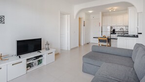 A modern living room with a flat-screen TV, a grey sofa, and a white entertainment unit. - Balcón del Mar by Interhome (Costa del Silencio)