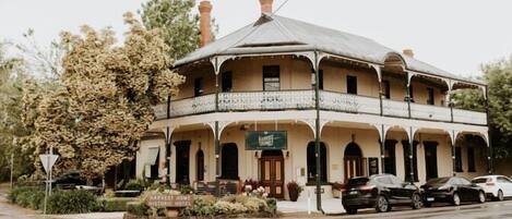 A historic hotel with a distinctive architectural style, featuring a central dome and multiple balconies.