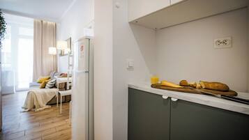 A modern kitchen with a countertop, a cutting board, a knife, and a loaf of bread.