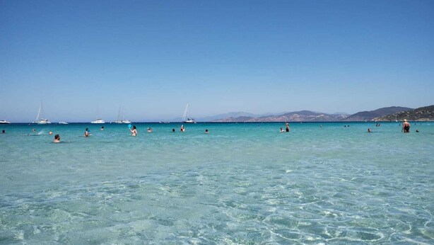 A clear blue sea with people swimming and boats in the distance. - New Villa Sea and Mountain View - Calenzana, near Calvi  (Calenzana)