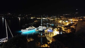 A marina at night with boats docked and illuminated by artificial lights. - New Villa Sea and Mountain View - Calenzana, near Calvi  (Calenzana)