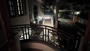 A staircase with ornate metal railings leading to a balcony. - Nivas In Lucknow (Lucknow)
