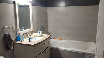 Shower, jetted tub, towels, soap