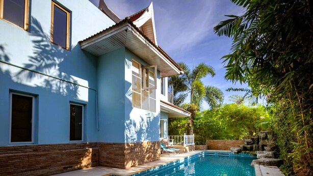 A two-story house with a swimming pool, surrounded by lush greenery and a small waterfall feature. - Mountain View Villa Kamala (Kamala Subdistrict, Kathu District)
