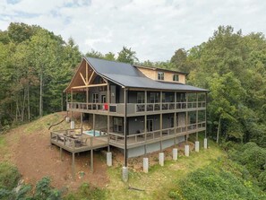 A multi-story building with a deck and a swimming pool.
