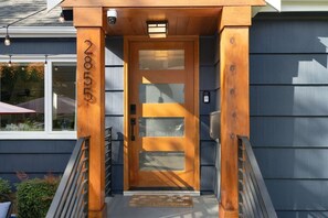 A wooden front door with a glass panel and a small window above it. - 3 BDRM Luxury Craftsmen | Queen Anne | Family/Pet+ (Seattle)