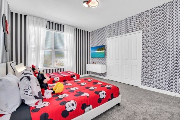 A bedroom with two beds, striped curtains, a white wardrobe, and a heart-patterned wall. - 2669pet 5 Bedroom Villa (Kissimmee)