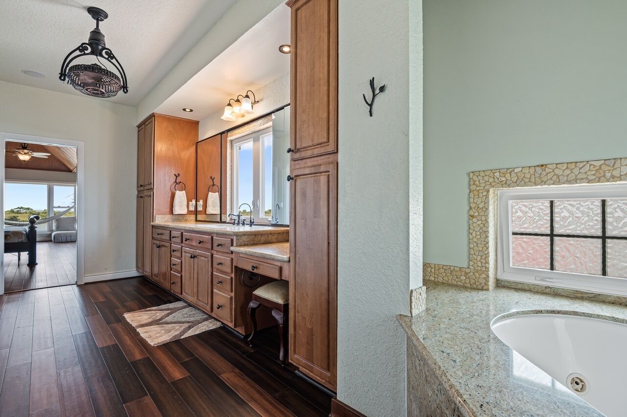 A kitchen with wooden cabinets, a granite countertop, and a built-in sink.