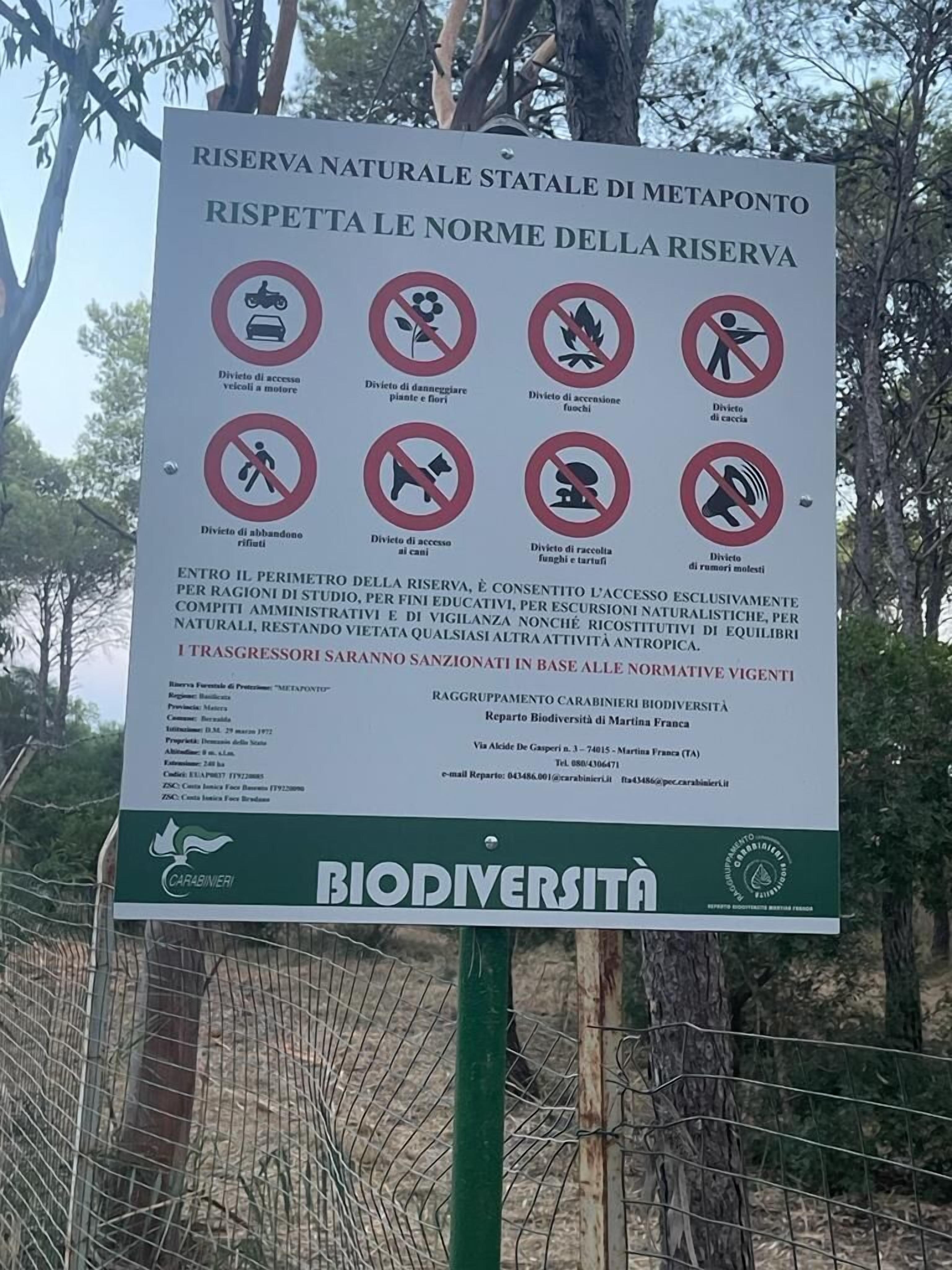 A sign with various prohibitions and information about a natural reserve, including no motor vehicles, no littering, and no noise.