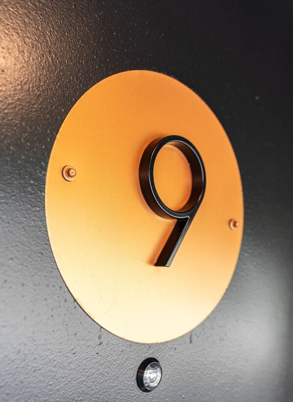 Un panneau circulaire avec le chiffre « 9 » noir sur un fond jaune.