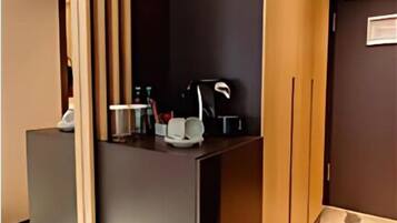 A reception area with a counter, a coat rack, and a wall-mounted clock.