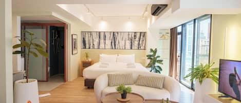 Luxury Quadruple Room, City View | Living area | 35-inch TV with digital channels