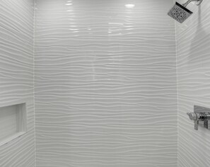 A bathroom with a textured white wall and a shower with a handheld showerhead. - 12 - 3BR $700+ in freebies incl golf, On Beach (Miramar Beach)