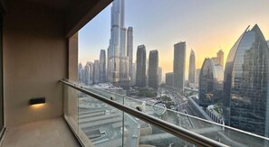 A balcony with a cityscape view, including modern skyscrapers and a bridge.